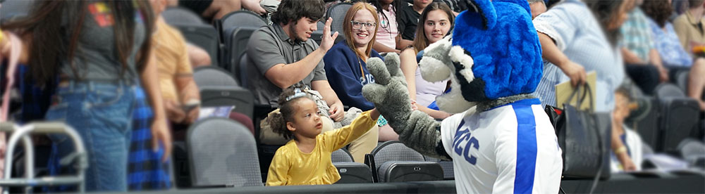 2023 Commencement Recap - MCC Wolf greeting family members and friends of the graduates