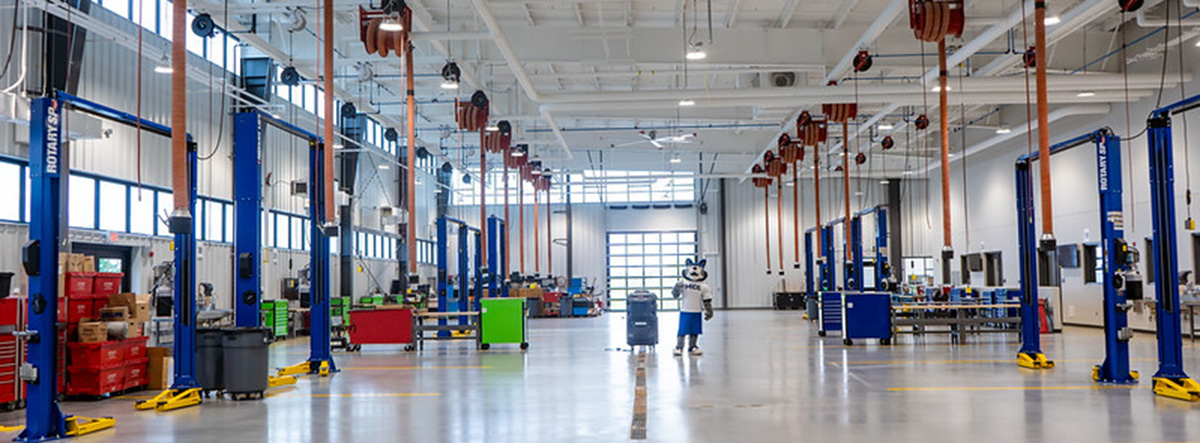MCC Wolf standing in the middle of the Automotive Institute car bays